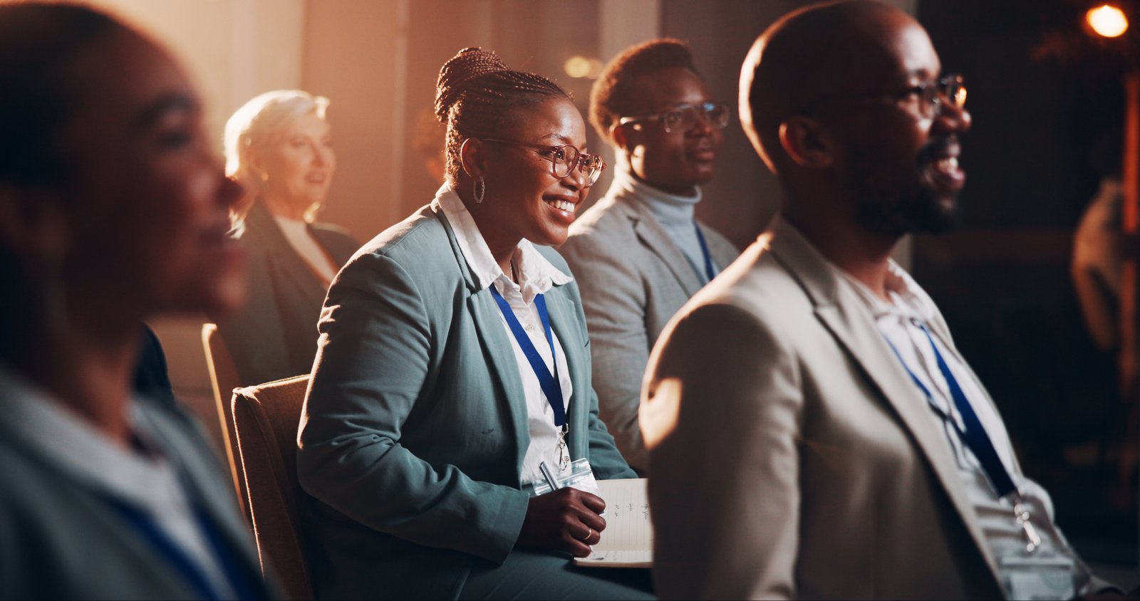 Business professionals smiling during a corporate conference